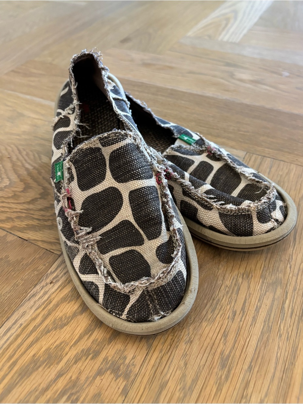 Sanuk Women’s Slip-On Canvas Shoes in Chocolate, Cream, and Bronze Giraffe Print